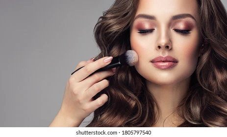About Us makeup artist applies powder blush 260nw 1805797540